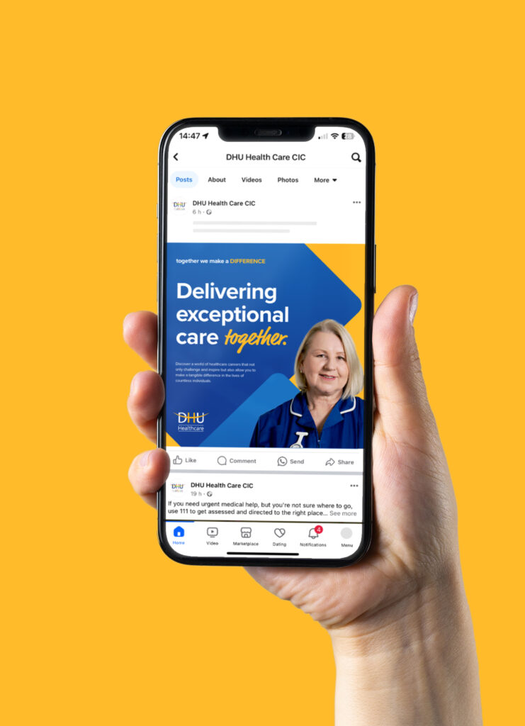 A hand holds a smartphone displaying a Facebook post from DHU Health Care CIC, showcasing their Social Media strategy with a nurse and the text, Delivering exceptional care together, on a blue background, set against a solid yellow backdrop.